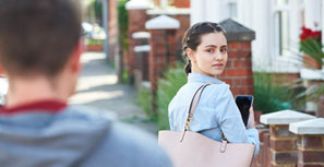 man walking after woman on street